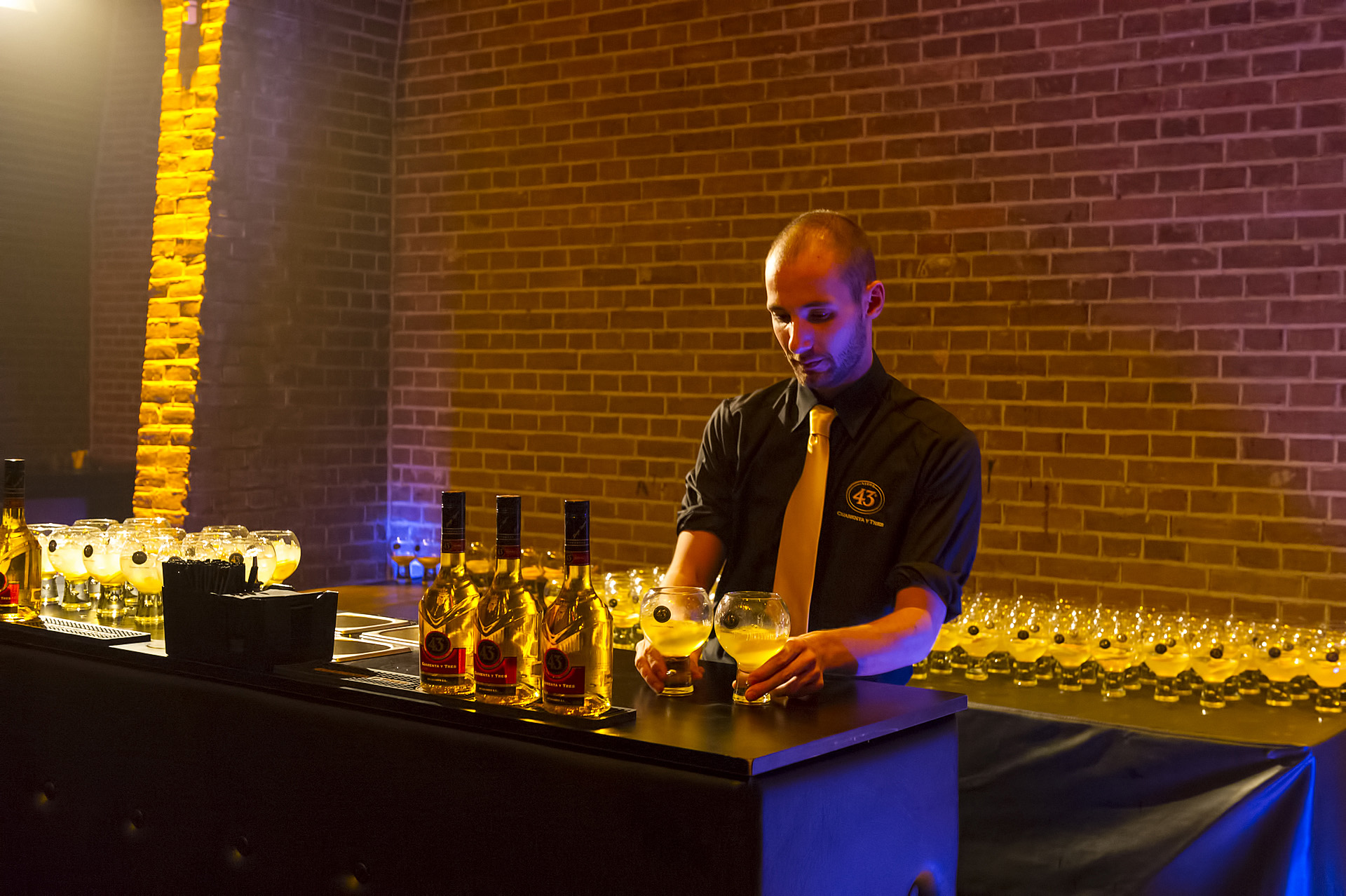 photo of a bartender prepping drinks